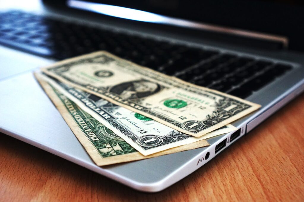 Photo of cash on a laptop