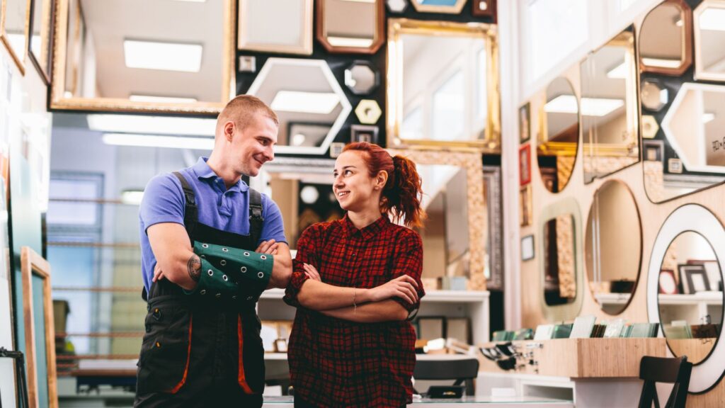 Photo of a married couple inside their retail local business.