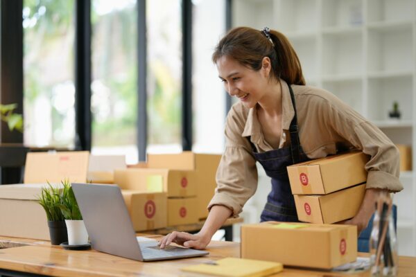Photo of a woman business owner fulfilling an online order.