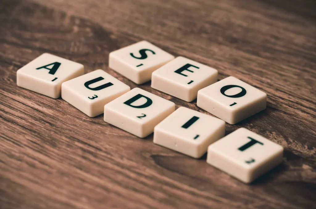 Seo Audit White Blocks on Brown Wooden Surface (Photo by Pixabay)