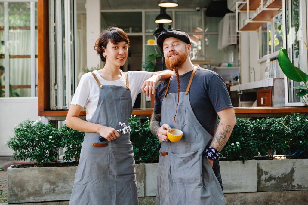 Couple of barista coworkers spending time in street near cafe (Photo by Tim Douglas)