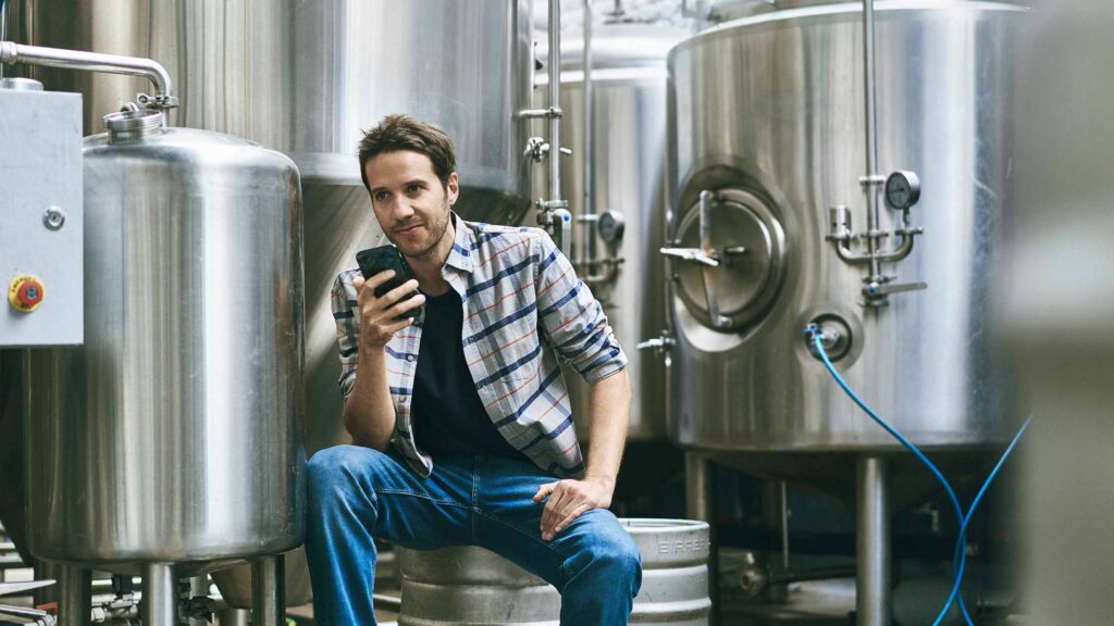 Photo of brewmaster posting to social media.